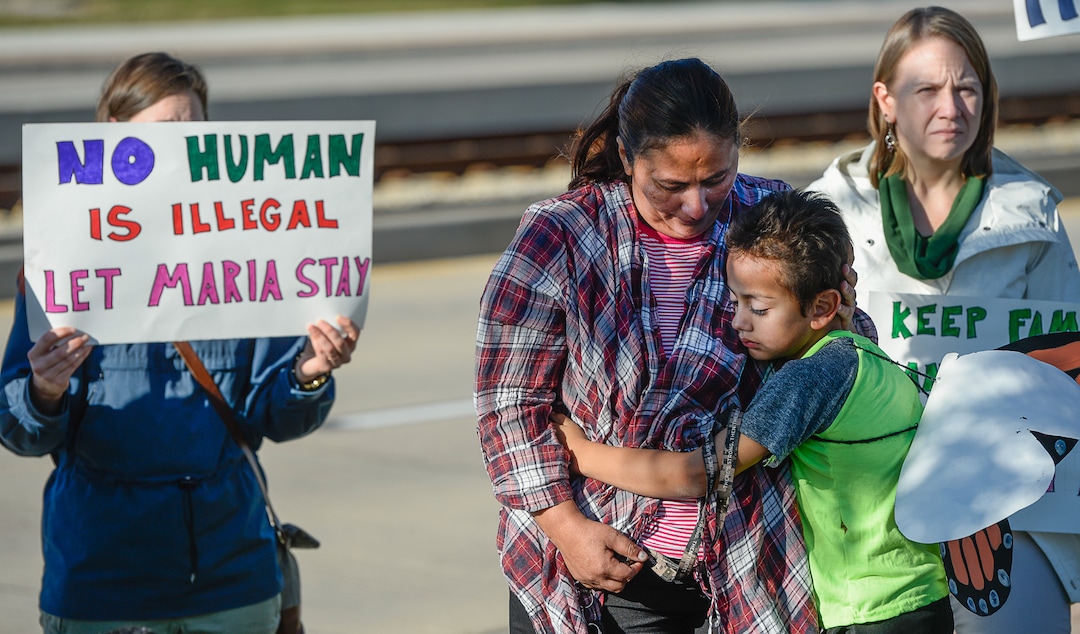 (Francisco Kjolseth  |  The Salt Lake Tribune)  Maria Santiago Garcia is embraced by her son Anthony Fajardo, 5, as community members rally in front of the Immigration and Customs Enforcement offices in West Valley City on Monday, Oct. 16, 2017, to support her. The single Utah mother of four U.S. born children faces an impending deportation order.