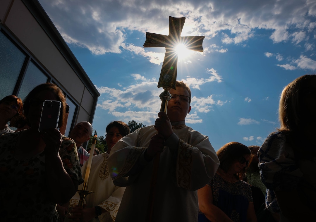 (Francisco Kjolseth  |  The Salt Lake Tribune) Altar boy Caleb Mau holds a cross as people gather at the doors of St. Anna Greek Orthodox Church in Sandy opening services of the new church on Saturday, July 13, 2024.
