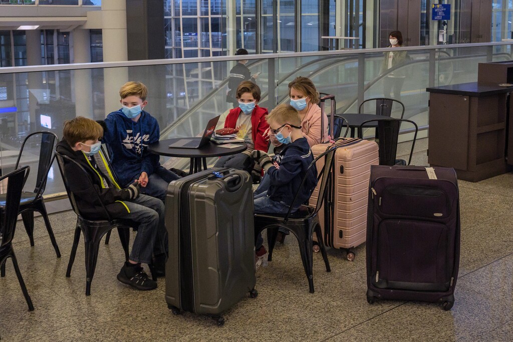 (Billy H.C. Kwok | The New York Times) Passengers wear face masks at the Hong Kong International Airport on Wednesday, Feb. 5, 2020. Hong Kong said that it will begin requiring people who arrive from mainland China to undergo a mandatory 14-day quarantine, as it tries to reduce the potential for imported cases of the coronavirus.
