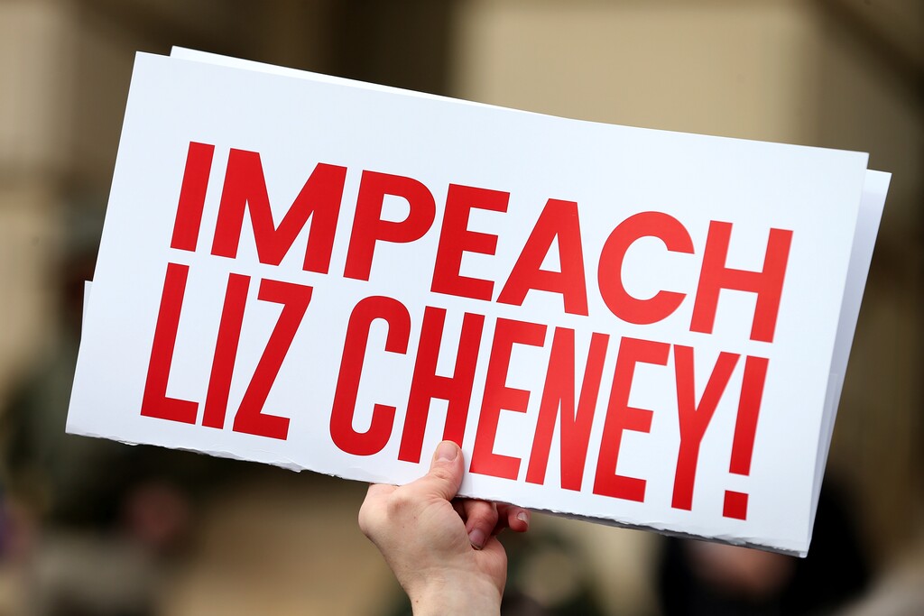 (Michael Cummo/The Wyoming Tribune Eagle via AP)

A protester holds an "Impeach Liz Cheney" sign during a rally against U.S. Rep. Liz Cheney, R-Wyo., Thursday, Jan. 28, 2021, outside the Wyoming State Capitol in Cheyenne. A nationwide fight for the GOP's future is getting fierce in Wyoming. House Republicans are expected to vote in the coming days on whether to oust congresswoman Liz Cheney from their third-ranking leadership post over her vote to impeach President Donald Trump.