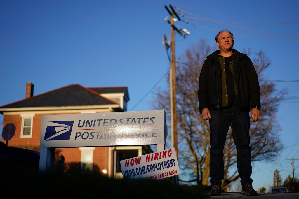(Carolyn Kaster | AP) Gerald Groff, a former postal worker whose case was argued before the Supreme Court, stands during a television interview near a "Now Hiring" sign posted at the roadside at the U.S. Postal Service, Wednesday, March 8, 2023, in Quarryville, Pa.