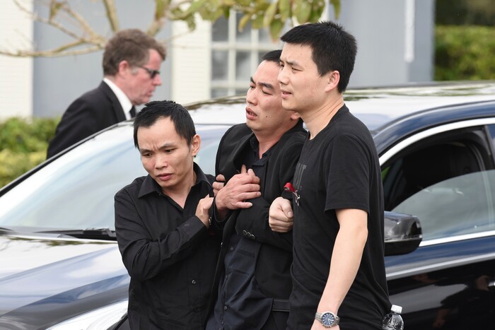 Family members hold up Peter Wang's father, Kong, after the funeral services for his 15-year-old son at Kraeer Funeral Home in Coral Springs, Fla. Peter Wang is a victim in the shooting at Marjory Stoneman Douglas High School.  (Taimy Alvarez/South Florida Sun-Sentinel via AP)
