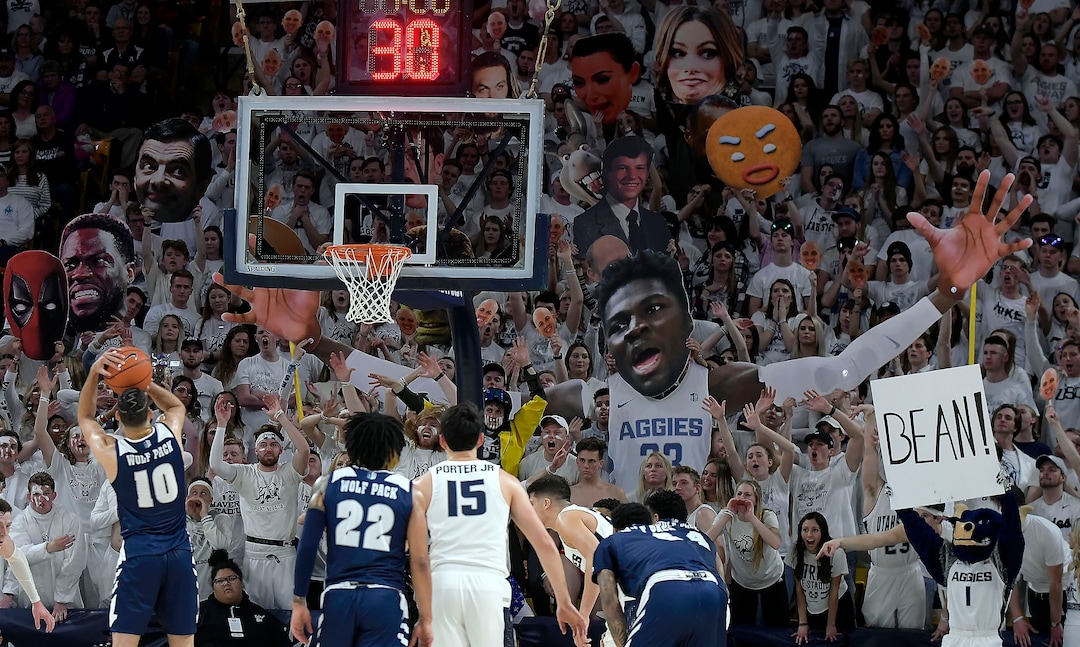 (Eli Lucero  |  The Herald Journal via AP) Utah State fans try to distract Nevada forward Caleb Martin (10) as he shoots a free throw during an NCAA college basketball game Saturday, March 2, 2019, in Logan, Utah.