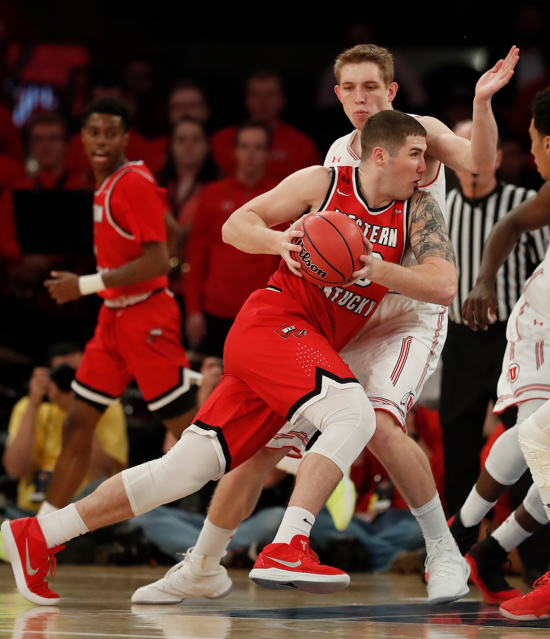 Western Kentucky forward Justin Johnson (23) drives against Utah forward Tyler Rawson (21) during the first half of an NCAA college basketball game in the semifinals of the NIT, Tuesday, March 27, 2018, in New York. (AP Photo/Julie Jacobson)