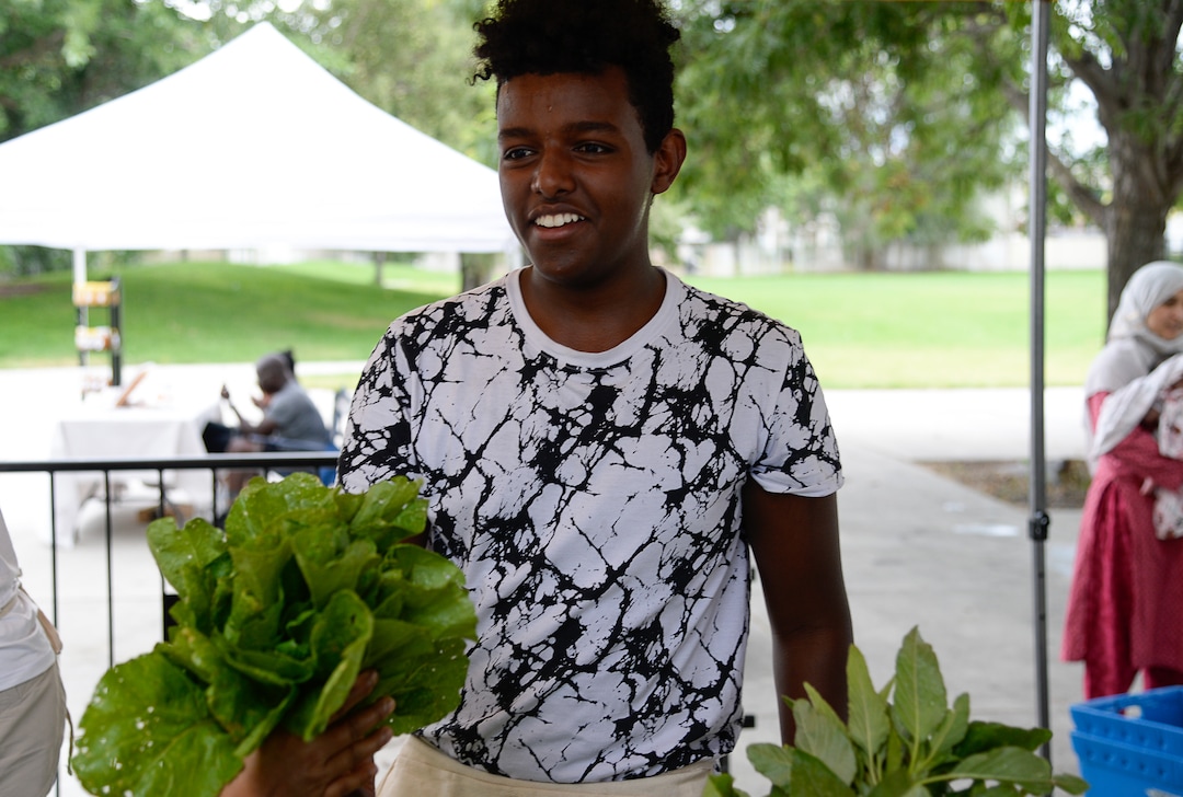 (Francisco Kjolseth  |  The Salt Lake Tribune)   Mohamed Salih, a refugee from Eritrea helps run the Sunnyvale Farmers Market at 4013 S. 700 West, which draws a weekly refugee clientele on Saturday, July 13, 2019, selling food grown exclusively by refugees living in Utah.