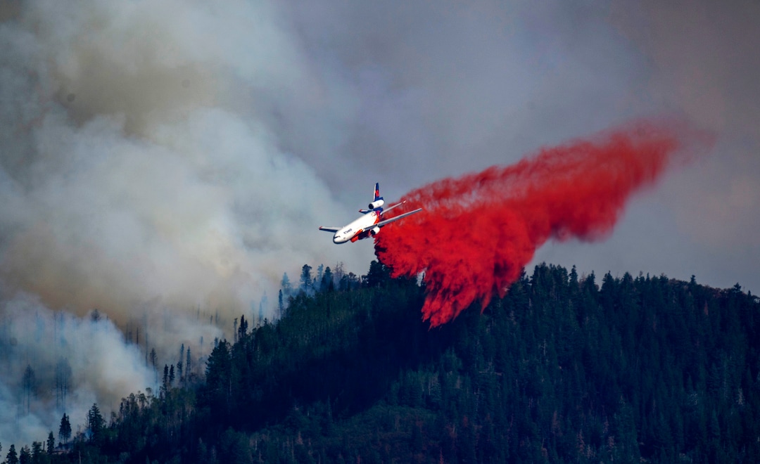 (Rick Egan | The Salt Lake Tribune) A plane drops fire retardant on the fire in Parley's Canyon, on Saturday, Aug. 14, 2021.