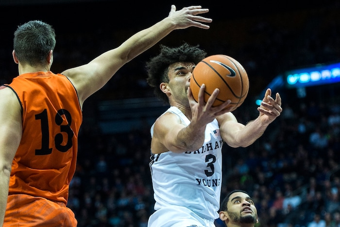 (Chris Detrick  |  The Salt Lake Tribune)  Brigham Young Cougars guard Elijah Bryant (3) shoots past Idaho State Bengals center Novak Topalovic (13) and Idaho State Bengals guard Brandon Boyd (15) during the game at the Marriott Center Thursday, December 21, 2017.  