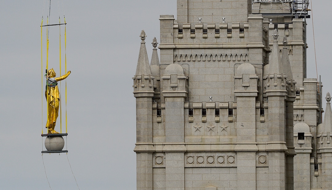 (Francisco Kjolseth  |  The Salt Lake Tribune) Crews work to remove the Angel Moroni statue atop the Salt Lake Temple of The Church of Jesus Christ of Latter-day Saints on Monday, May 18, 2020. The temple closed in December for seismic upgrades and sustained minor damager during the March 18, 2020, magnitude 5.7 earthquake when the trumpet held by the angel fell off and several smaller spire stones were displaced.