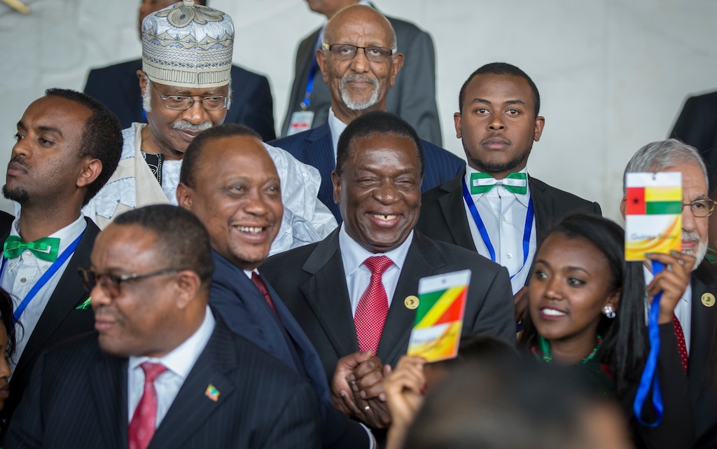(AP Photo/Mulugeta Ayene) Kenya's President Uhuru Kenyatta, center left, laughs with Zimbabwe's President Emmerson Mnangagwa, center, at the opening ceremony of the African Union summit in Addis Ababa, Ethiopia Sunday, Jan. 28, 2018. The leaders of the United Nations and the African Union urged stronger international cooperation at the opening Sunday of the African Union summit in the Ethiopian capital, Addis Ababa.