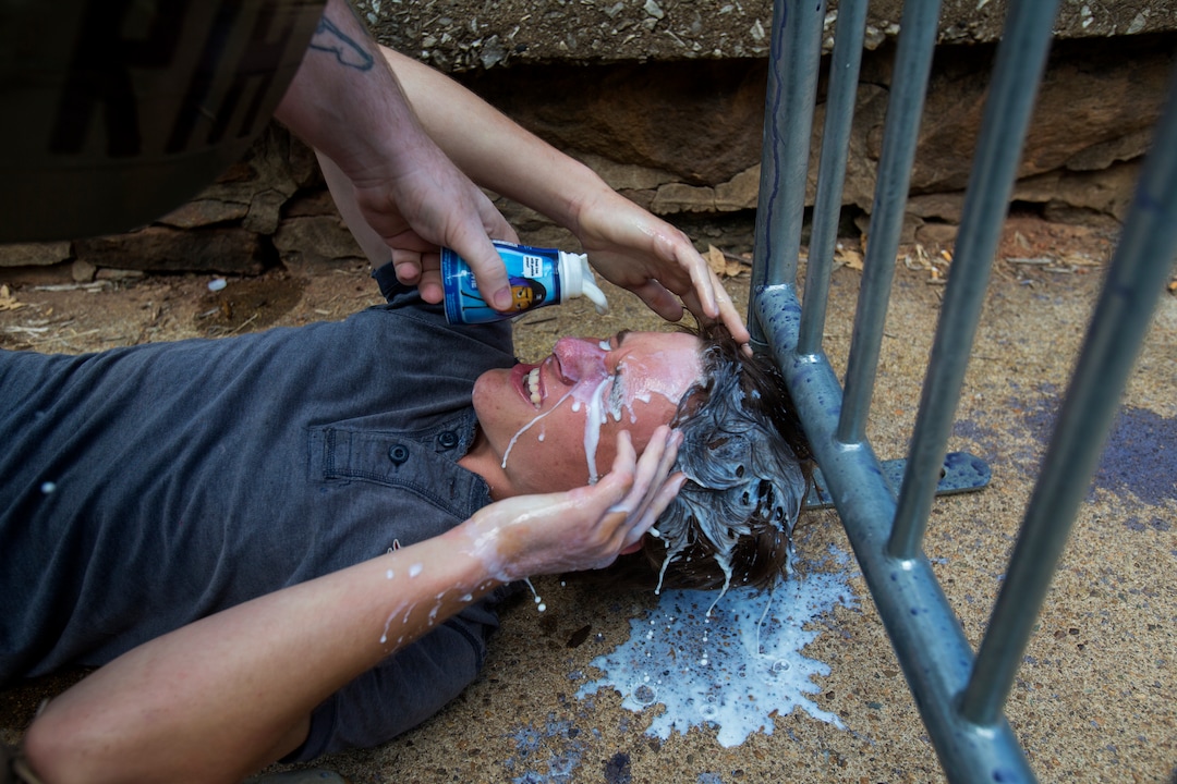 A counter-protester gets milk poured onto his face after getting pepper sprayed during a white nationalist rally on Saturday Aug. 12, 2017, in Charlottesville, Va. The nationalists had gathered to protest plans by the city of Charlottesville to remove a statue of Confederate Gen. Robert E. Lee and others arrived to protest the racism. (Shaban Athuman /Richmond Times-Dispatch via AP)