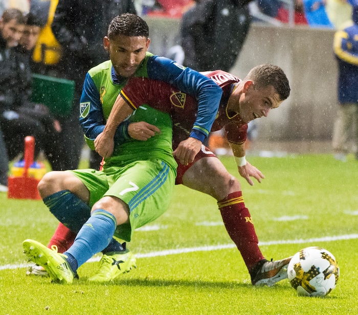 (Rick Egan  |  The Salt Lake Tribune)  Real Salt Lake forward Brooks Lennon (27) gets tangled up with Seattle Sounders midfielder Cristian Roldan (7), as he goes for the ball, in MLS soccer action, Real Salt Lake vs Seattle Sounders, in Sandy, Utah, Saturday, September 23, 2017.