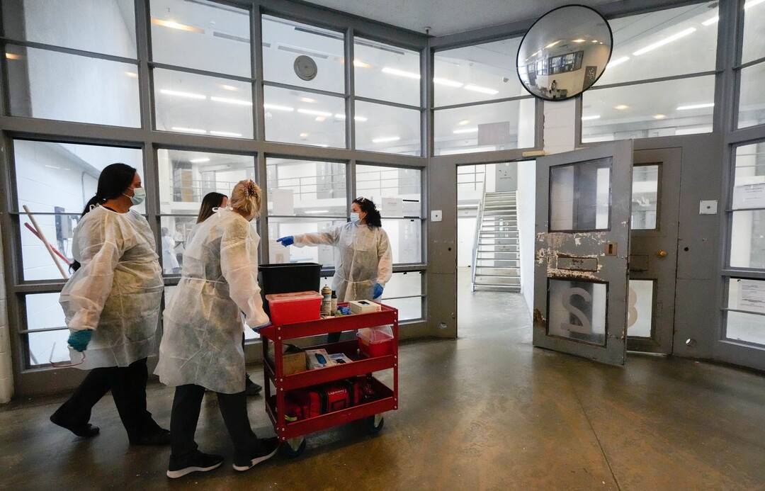 (Francisco Kjolseth | The Salt Lake Tribune) Nomi Health, the direct healthcare company coordinating COVID-19 testing and vaccination efforts across the country and Utah Department of Corrections collaborate to provide the COVID-19 vaccine for incoming inmates at the Utah State Prison in Draper, on Tuesday, July 27, 2021, as they move from pod to pod for inmates who agreed to get the vaccine.