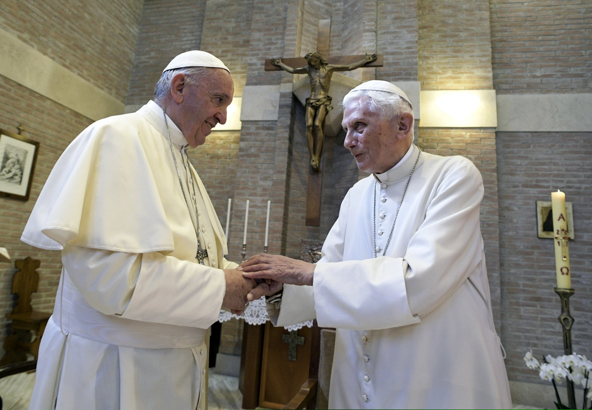 (L'Osservatore Romano | Pool photo via AP) Pope Francis, left, and Pope Benedict XVI, talk in 2017.