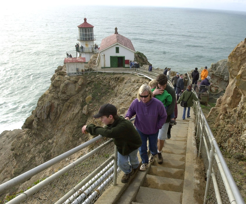 Visitors make their way up the steps leading to a lighthouse at the Point Reyes National Seashore in Point Reyes, Calif., Sunday, Dec. 29, 2002. The lighthouse was built in 1870 to keep sailors from crashing into the rocky shore as they navigated into and out of San Francisco Bay, 35 miles to the southeast. Today, an automated electric light and fog horn warn mariners of the rocky shore below, but the original Point Reyes Lighthouse, on the tip of a peninsula north of San Francisco, remains as a testament to California's maritime past. Years of wind, fog and harsh sea air have left the structure in need of repairs, so the 132-year-old lighthouse is being restored as part of a $1.2 million project by the National Park Service. (AP Photo/Marcio Jose Sanchez)