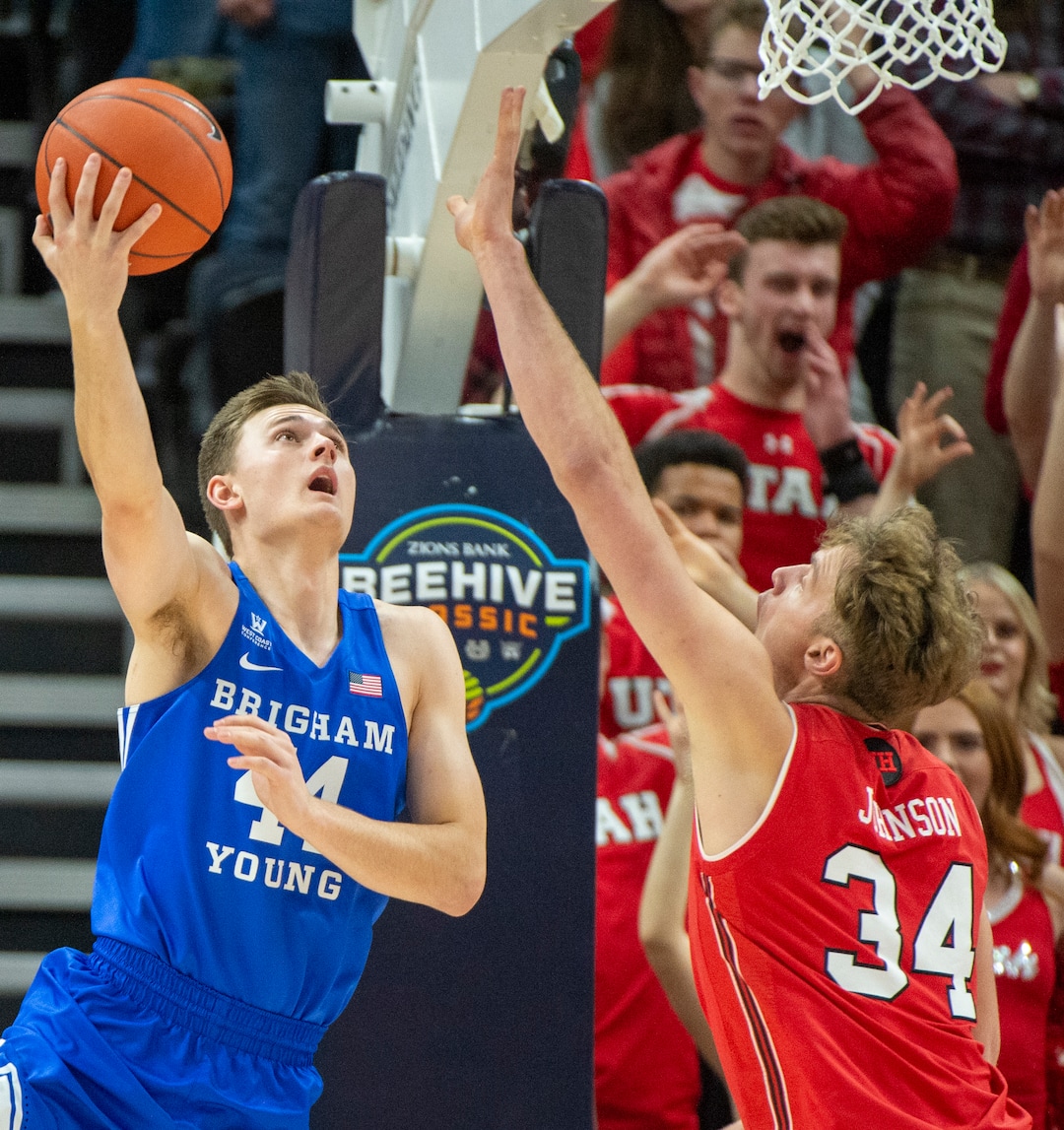 (Rick Egan  |  The Salt Lake Tribune)   Brigham Young Cougars guard, Connor Harding shoots as Utes center Jayce Johnson (34) dunks the ball and takes out against the Brigham Young Cougars forward Dayton Nixon (33) on the play in basketball action in the Beehive Classic, between against the Brigham Young Cougars and Utah Utes, at the Vivint Smart Home Arena, Saturday December 8, 2018