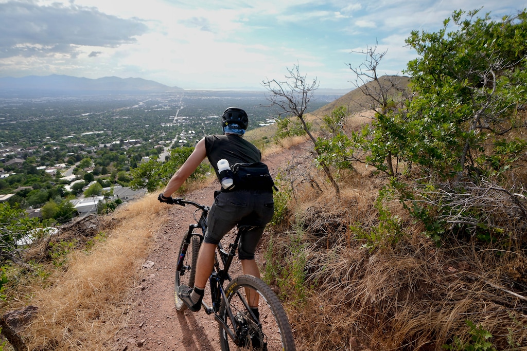 (Francisco Kjolseth | The Salt Lake Tribune) After an 1,100-foot climb, the new Parley's Pointe Trail provides expansive views of the Salt Lake Valley as a rider is treated to the view on Wednesday, Aug. 10, 2022. The 4.8-mile trail is part of the Bonneville Shoreline Trail and winds between the Parley's Trail bike path and the Arcadia trailhead on Lakeline Drive.