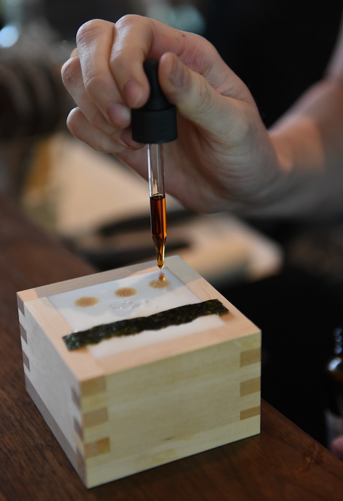 (Francisco Kjolseth  |  The Salt Lake Tribune)  Bartender Crystal Daniels puts the finishing touches on a Nikkei Sour with barsol pisco, ponzu, lime, egg white, chuncho bitters and served inside a cedar box at the Post Office Place, a new bar by the same owners as Takashi, located next door, welcomes patrons on Tuesday, June 19, 2018.
