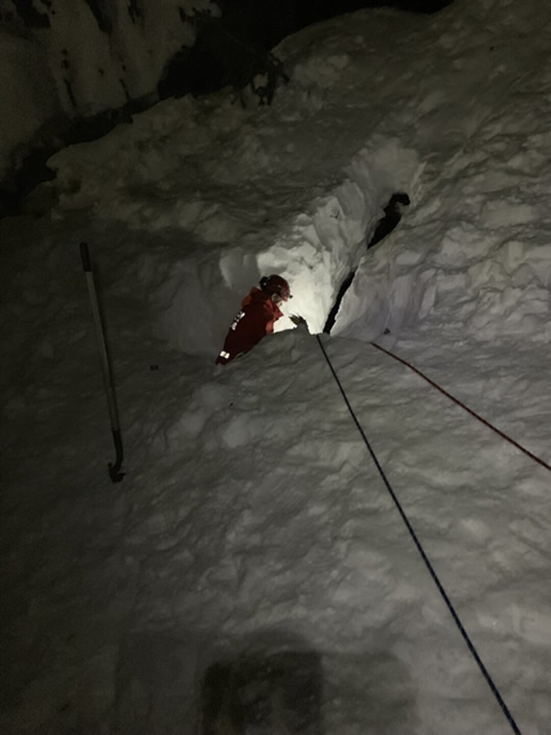 (Photo courtesy of the Utah County Sheriff's Office) A rescuer rappels into a 40-foot snow cavern at Stewart Falls near Sundance Ski Resort,  to rescue a dog that fell through a hole in the ceiling on Saturday, Feb. 2.