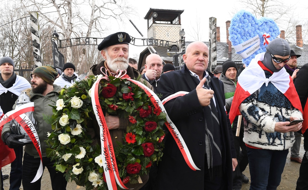 Polish far-right activists enter the former German Nazi death camp Auschwitz-Birkenau, on International Holocaust Remembrance Day in Oswiecim, Poland, Sunday, Jan. 27, 2019.(AP Photo)