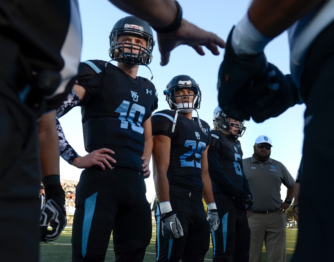 Leah Hogsten  |  The Salt Lake Tribune  West Jordan's quarterback Oakley Kopp, running back Isaiah Lapale and wide receiver Kalleb Klenk prepare to meet Riverton High School, Thursday, Sept. 13, 2018 in West Jordan. 