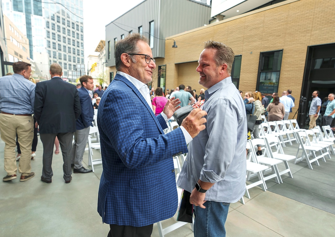 (Leah Hogsten | The Salt Lake Tribune)  From left, David Brint, principal with Brinshore Development and Danny Walz, director of the Redevelopment Agency of Salt Lake City, share a laugh at the opening of The Aster, a new complex at 255 S. State, which offers 190 residential and mixed-income units, open-air spaces and community gathering spaces, May 2, 2023.