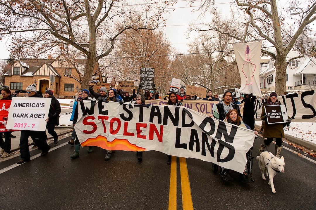 (Trent Nelson | The Salt Lake Tribune)  Protesters march down State Street during rally against a visit by President Donald Trump, Monday December 4, 2017.