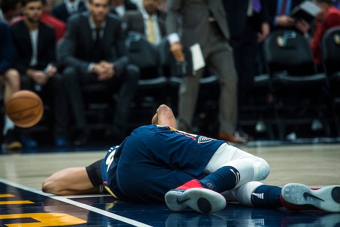 (Chris Detrick  |  The Salt Lake Tribune)  New Orleans Pelicans forward Anthony Davis (23) remains on the ground after getting injured during the game at Vivint Smart Home Arena Friday, December 1, 2017.  Utah Jazz defeated New Orleans Pelicans 114-108.
