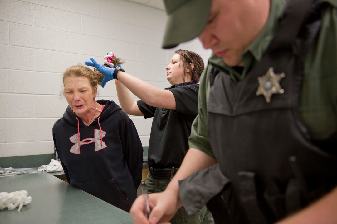 Linda Green, 51, who has struggled with drug addiction, cries as she's booked into the Campbell County Jail after being arrested on charges of public intoxication, a parole violation, in Jacksboro, Tenn., Thursday, March 29, 2018. Women in jail are the fastest-growing correctional population in America. Between 1980 and 2009, the arrest rate for drug possession or use tripled for women, while it doubled for men. Opioid abuse has exacerbated the problem. (AP Photo/David Goldman)