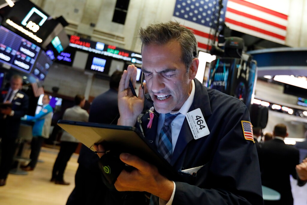 Trader Gregory Rowe works on the floor of the New York Stock Exchange, Monday, Aug. 5, 2019. Stocks plunged on Wall Street Monday on worries about how much President Donald Trump's escalating trade war with China will damage the economy. (AP Photo/Richard Drew)