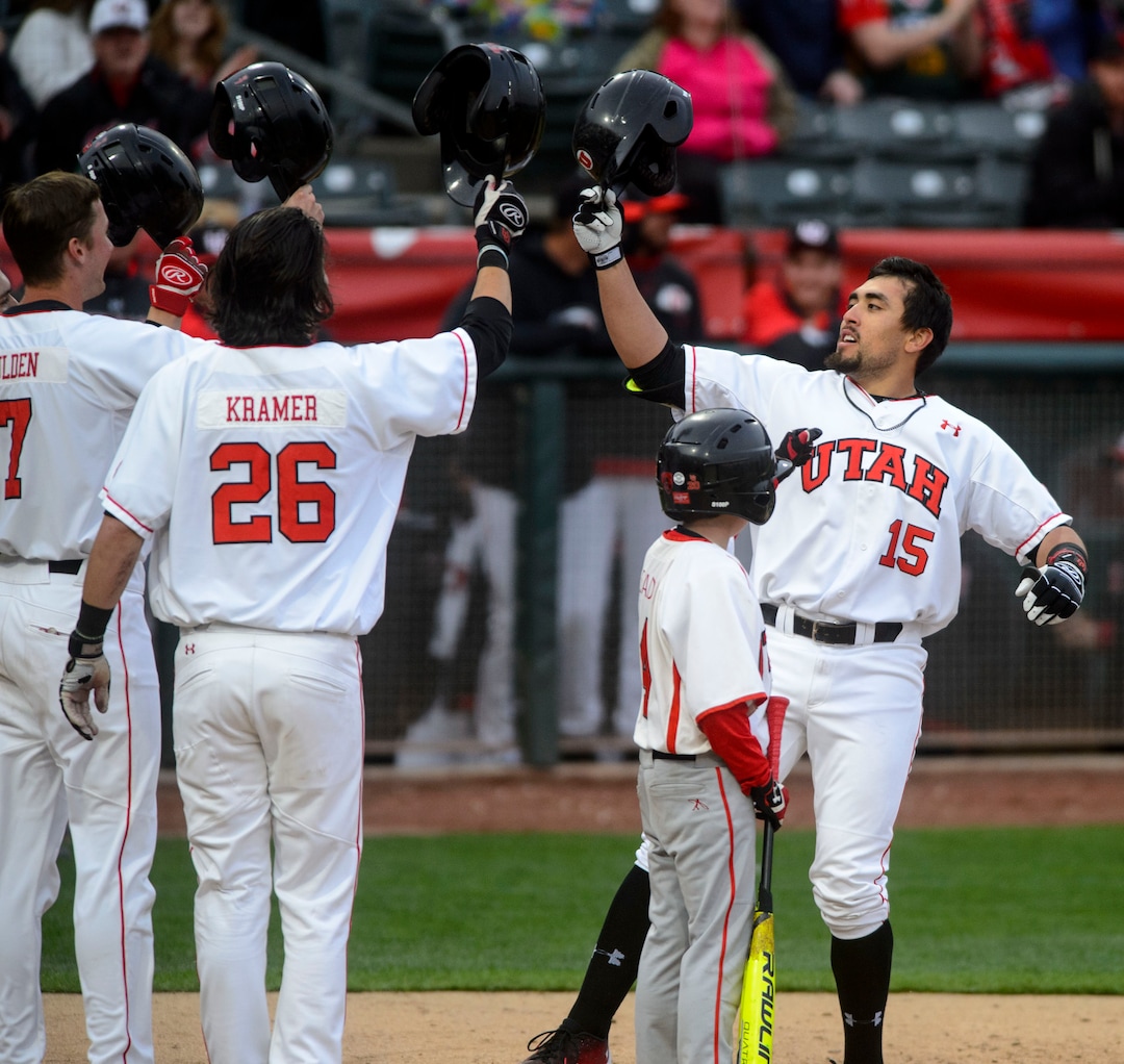 (Steve Griffin  |  The Salt Lake Tribune)  Utah's Erick Migueles taps helmets with his teammates after blasting a three-run homer during the BYU versus Utah baseball game at Smiths Ballpark in Salt Lake City Tuesday April 3, 2018.