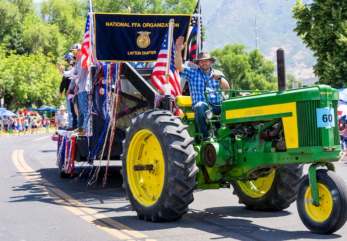 (Rick Egan | The Salt Lake Tribune)  A tractor pulls the participants in the Layton Chapter of FFA, in the Layton Liberty Days Parade, on Monday, July 5, 2021.