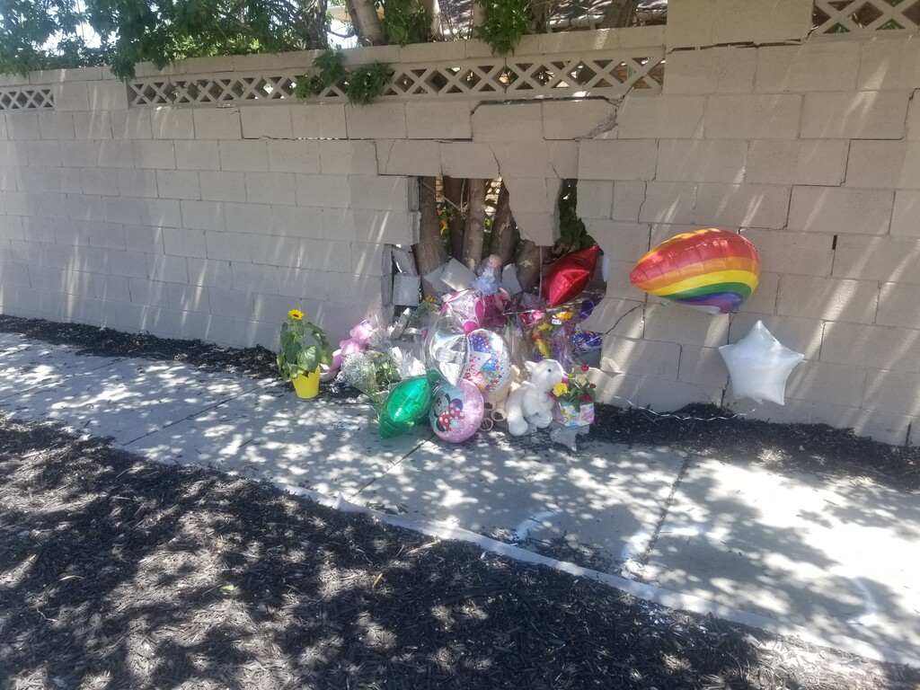 (Dan Harrie | The Salt Lake Tribune) A makeshift memorial was made by neighbors Wednesday, July 30, 2020 at the place where a 2-year-old girl was killed in Taylorsville as the result of a car hitting her, her mother and her twin sister on Tuesday.