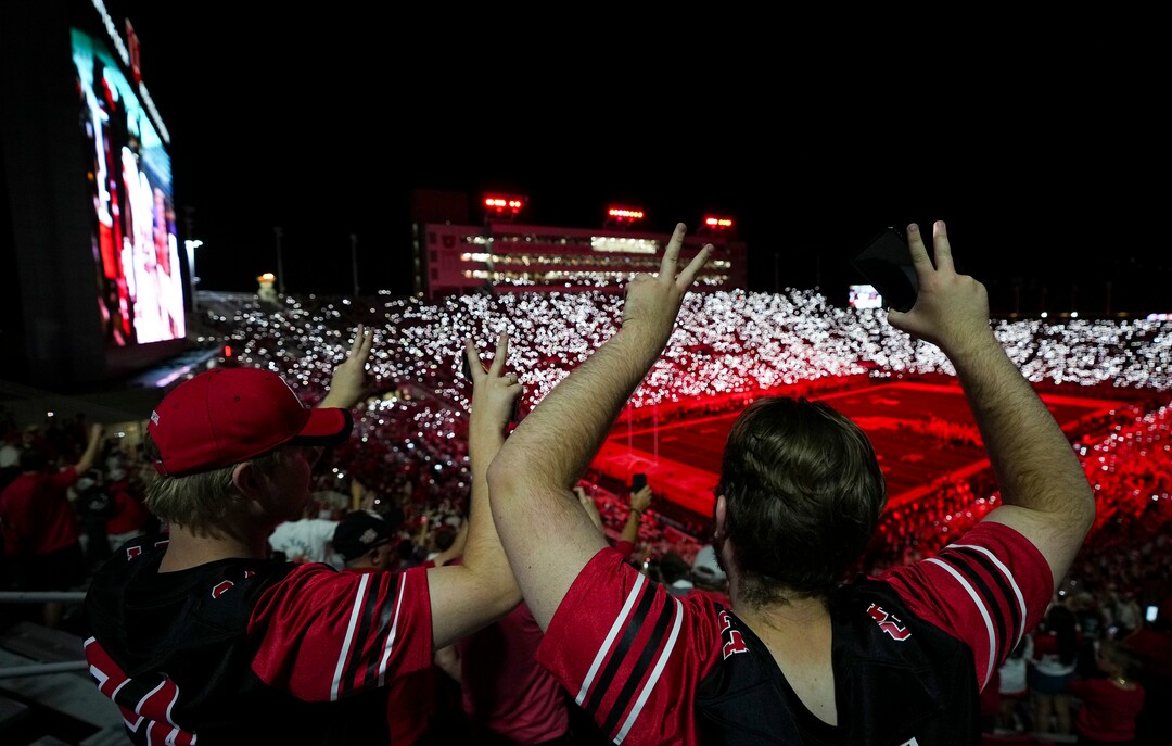 (Bethany Baker  |  The Salt Lake Tribune) Two Utah Utes fans hold up two fingers on each of their hands between the third and fourth quarters, a Utah Utes tradition to honor two former players who died, during the second half of the game between the Utah Utes and the Idaho Vandals at Rice-Eccles Stadium in Salt Lake City on Thursday, Sept. 3, 2026.