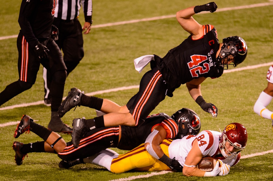 (Trent Nelson  |  The Salt Lake Tribune) Utah Utes defensive end Mika Tafua (42) flies over USC Trojans tight end Erik Krommenhoek (84), as the Utah Utes host the USC Trojans, NCAA football at Rice-Eccles Stadium in Salt Lake City on Saturday, Nov. 21, 2020.