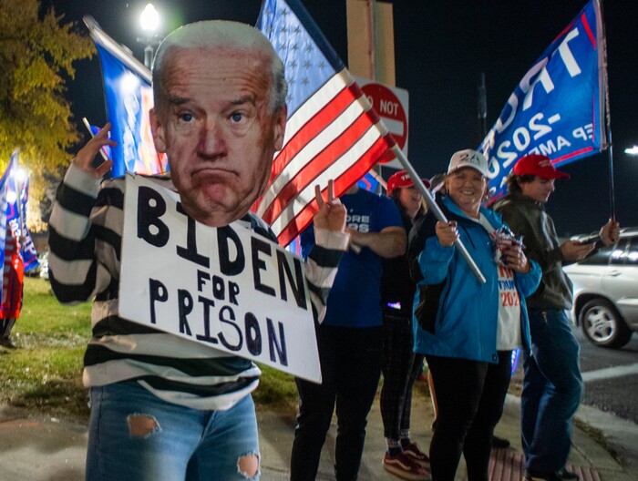 (Rick Egan | The Salt Lake Tribune) Trump supporters wave flags during a Trump rally at Washington Square, on Monday, Nov. 2, 2020.