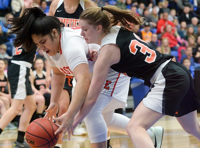 (Leah Hogsten  |  The Salt Lake Tribune) East's Lani Taliauli (54) and Timpview's Taylor Ross (31) fight for the rebound.  East faces Timpview in the championship game of the 5A High School Girls' Basketball Tournament at SLCC in Taylorsville, Saturday, Feb. 24, 2018.