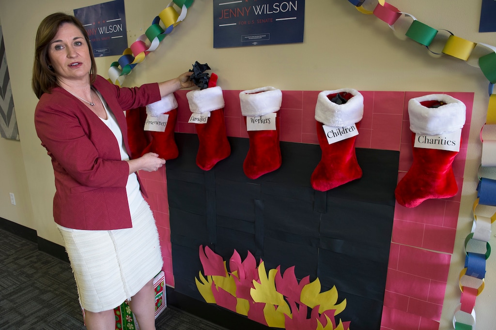 (Scott Sommerdorf | The Salt Lake Tribune)
U.S. Senate candidate Jenny Wilson, a Salt Lake County councilwoman, demonstrates the uncertainty Utahns face after the passage of the new tax plan by Congress by saying there is "coal" in the Christmas stockings of families, workers and children after a press conference, Thursday, December 21, 2017.
