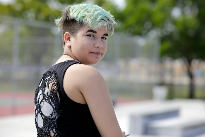 (Lynne Sladky | The Associated Press) In this Thursday, April 28, 2016 photo, Theo Ramos, 14, visits a neighborhood park in Homestead, Fla. Theo knew he sometimes “presented like a girl” _ like when he would Snapchat crowns of flowers on photos of his kitten, or how he colored his hair every shade of the rainbow. And he spent hours watching makeup artists on YouTube because, but, he said with a shrug, “you can be a boy and like makeup.”