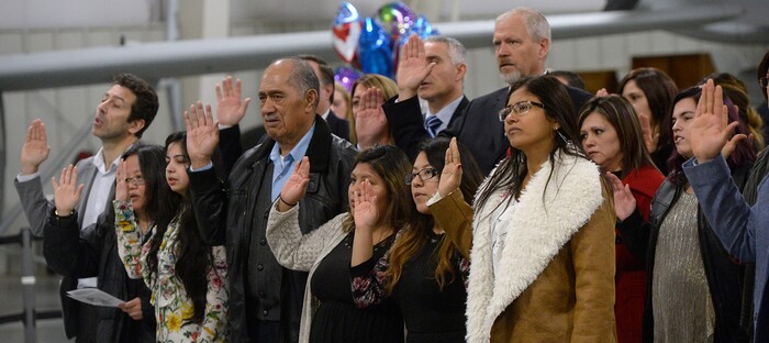 (Al Hartmann  |  The Salt Lake Tribune) 	
Thirty-five people from 24 countries raise their hand and take the oath of  allegiance to the United States in a naturalization ceremony by the U.S.  Citizenship and Immigration Service Tuesday Nov. 21 at the Hill Air Force Base Aerospace Museum.