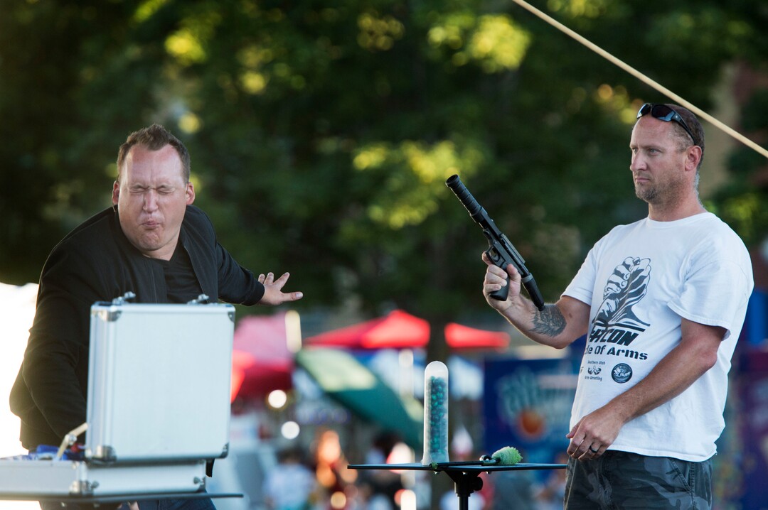 (Rick Egan  |  The Salt Lake Tribune)    Jared Sherlock, Comic Magician and Illusionist, reacts after catching a paintball in his teeth, shot by Kyle Henderson or North Salt Lake, at the Utah State Fair, Sunday, September 10, 2017.