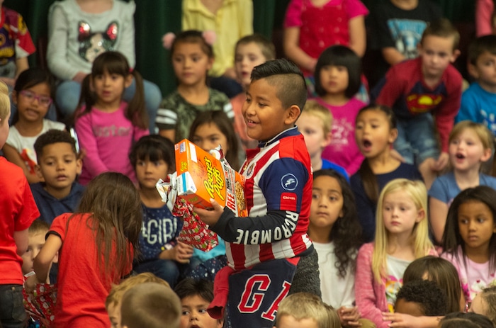 (Rick Egan  |  The Salt Lake Tribune)   First grade student, Hared Macedo smiles with his box of cereal. Ms. Worthington the principal, surprised all 650 students at her school with the gift-wrapped boxes of cereal, at Oquirrh Elementary in West Jordan, Thursday, Dec. 20, 2018.


