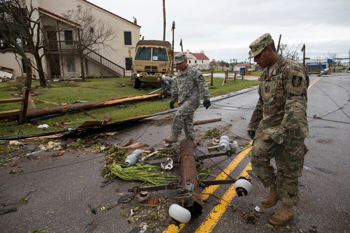 (Courtney Sacco | Corpus Christi Caller-Times via AP) Members of the Texas National Guard pull a utility poll from Fulton Beach Road on Sunday, Aug. 27, 2017, after Hurricane Harvey in Fulton, Texas. Harvey made landfall in Texas on Friday night as the strongest hurricane to hit the U.S. in more than a decade.