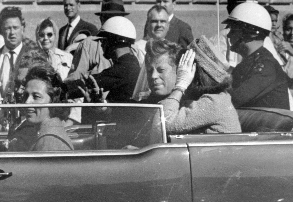 FILE - In this Nov. 22, 1963 file photo, President John F. Kennedy waves from his car in a motorcade in Dallas. Riding with Kennedy are First Lady Jacqueline Kennedy, right, Nellie Connally, second from left, and her husband, Texas Gov. John Connally, far left.  President Donald Trump, on Saturday, Oct. 21, 2017,  says he plans to release thousands of never-seen government documents related to President John F. Kennedy's assassination.  (AP Photo/Jim Altgens, File)