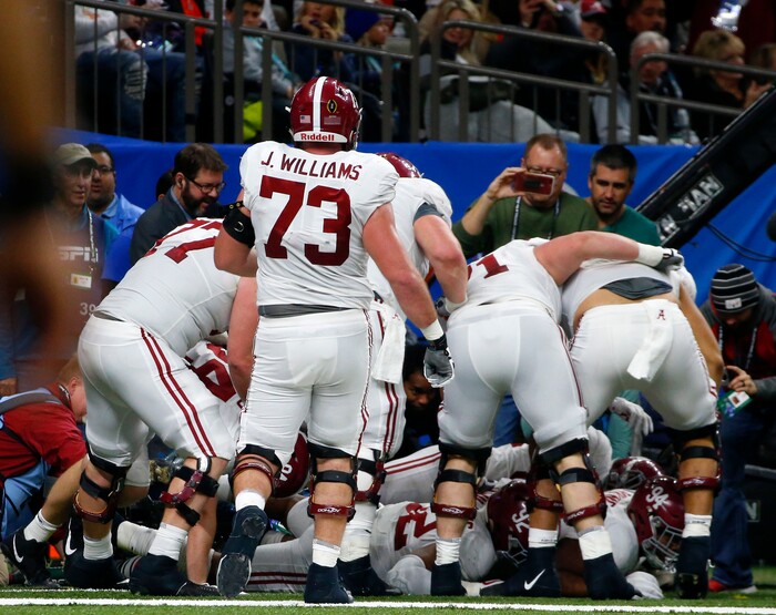 Alabama players pile on defensive lineman Da'Ron Payne, who was used in an offensive play, after he caught a touchdown reception in the second half of the Sugar Bowl semi-final playoff game against Clemson for the NCAA college football national championship, in New Orleans, Monday, Jan. 1, 2018. (AP Photo/Butch Dill)