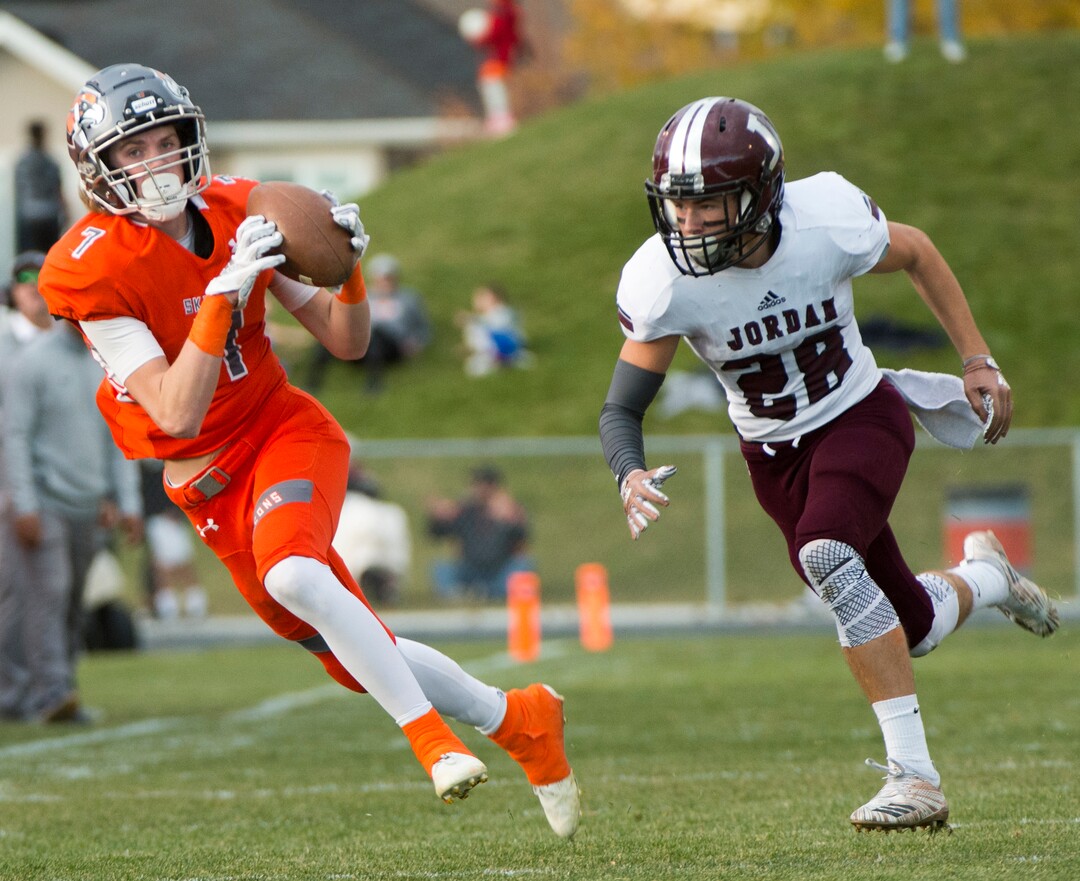 (Rick Egan  |  The Salt Lake Tribune)   Skyridge wide reciever Dylan Samuels catches a pass as Jordan High defensive back Alex Harston defends, in prep 5A playoff action, in Lehi, Friday, Nov. 2, 2018.