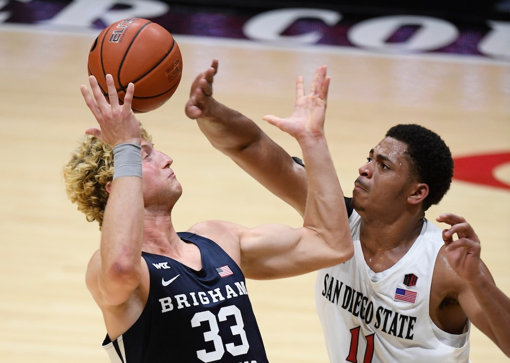 BYU forward Caleb Lohner (33) fights for the ball with San Diego State forward Matt Mitchell (11) during the second half of an NCAA college basketball game Friday, Dec. 18, 2020, in San Diego. (AP Photo/Denis Poroy)