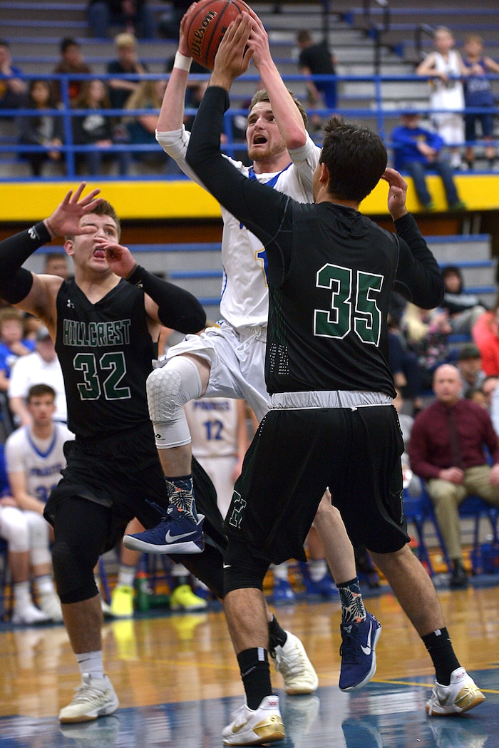 (Leah Hogsten | The Salt Lake Tribune) Cyprus' Alex Foster shoots around Hillcrest defense. Cyprus High School boys' basketball team defeated Hillcrest High School 77-61 during their game Tuesday, January 30, 2018 in Magna.