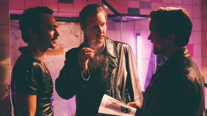 (Josef Persson | courtesy Kino Lorber Films) Finnish artist Touko Laaksonen (Pekka Strang, center), whose drawings inspired the gay "leather" lifestyle, meets two of his American fans (Seumas Sargent, left, and Jakob Oftebro) in the biographical drama "Tom of Finland."