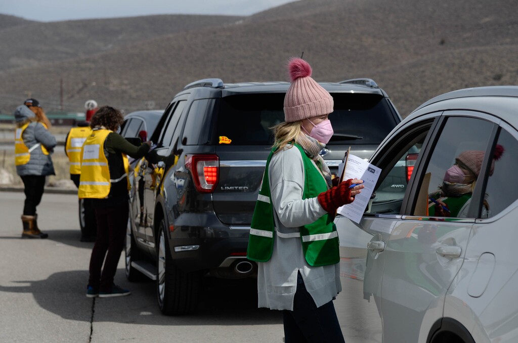 (Francisco Kjolseth  | The Salt Lake Tribune) Melissa Filippone helps people get checked in as they line up for the COVID-19 vaccine at the Utah Film Studios in Park City on Thursday, March 18, 2021. 