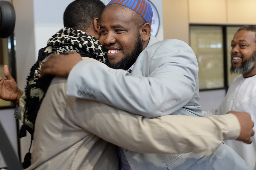 Scott Sommerdorf | The Salt Lake TribuneImam Yussuf Awadir Abdi gets hugs from friends after he arrived at Salt Lake City International airport, Sunday, June 18, 2017.